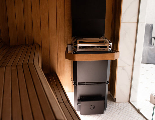 Saunum Air L with open stainless stone basket in a sauna
