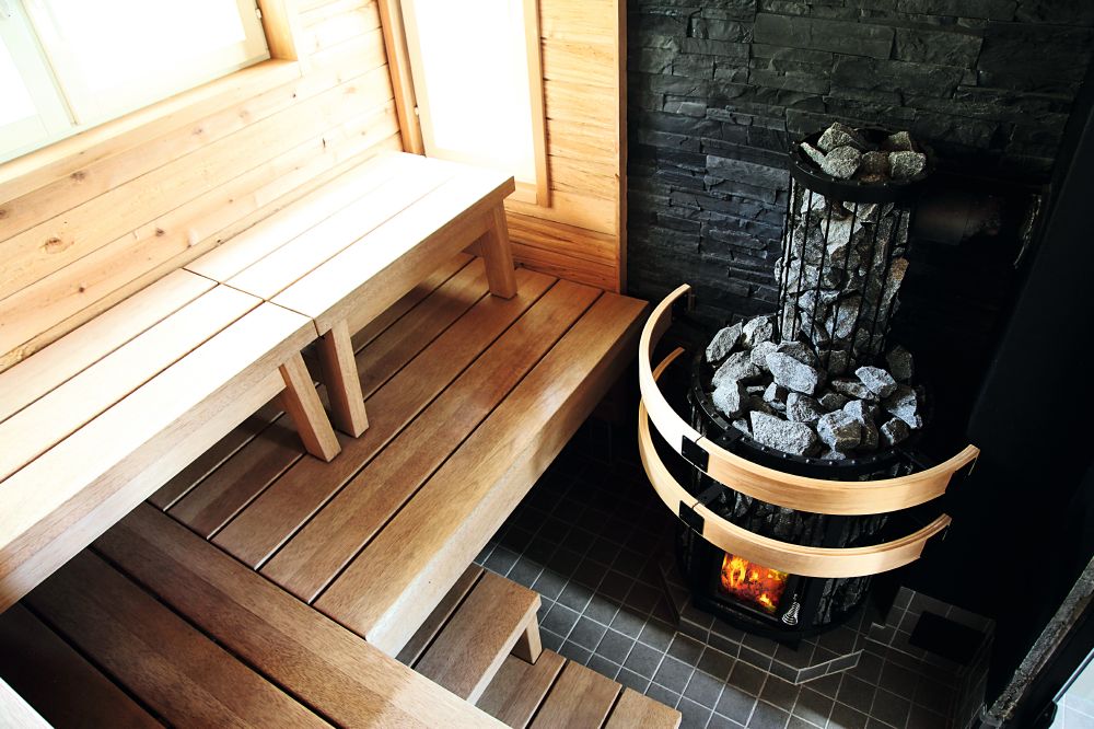Harvia Legend in a sauna with stone-filled smoke pipe cover