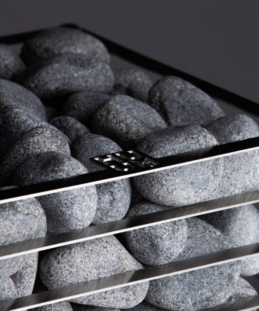 HUUM sauna stones in a heater pile